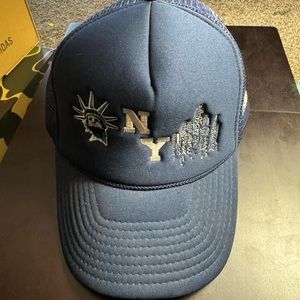 GBC NY “Home of The Hustlers” Trucker Hat. (Yankee Blue)